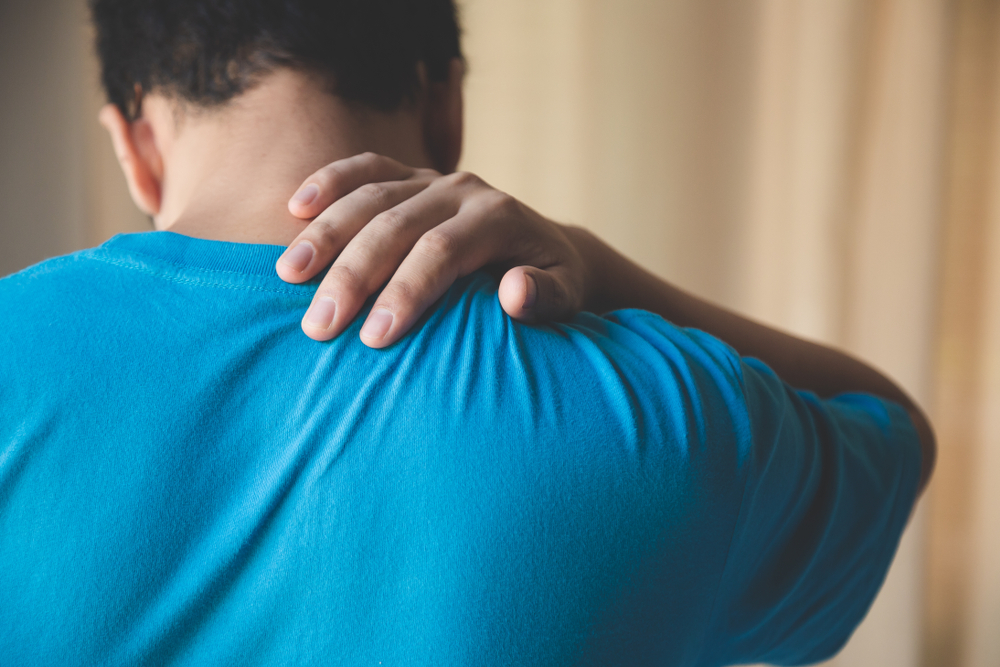 man suffering from back pain following a car accident,  physical therapy car accident