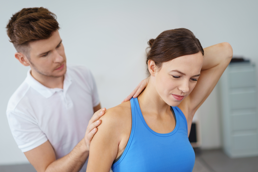 woman undergoing joint mobilization from her physical therapist
