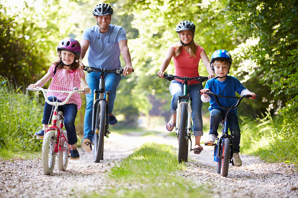 A family riding bikes in the summer.